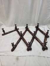 Concertina action coat pegs